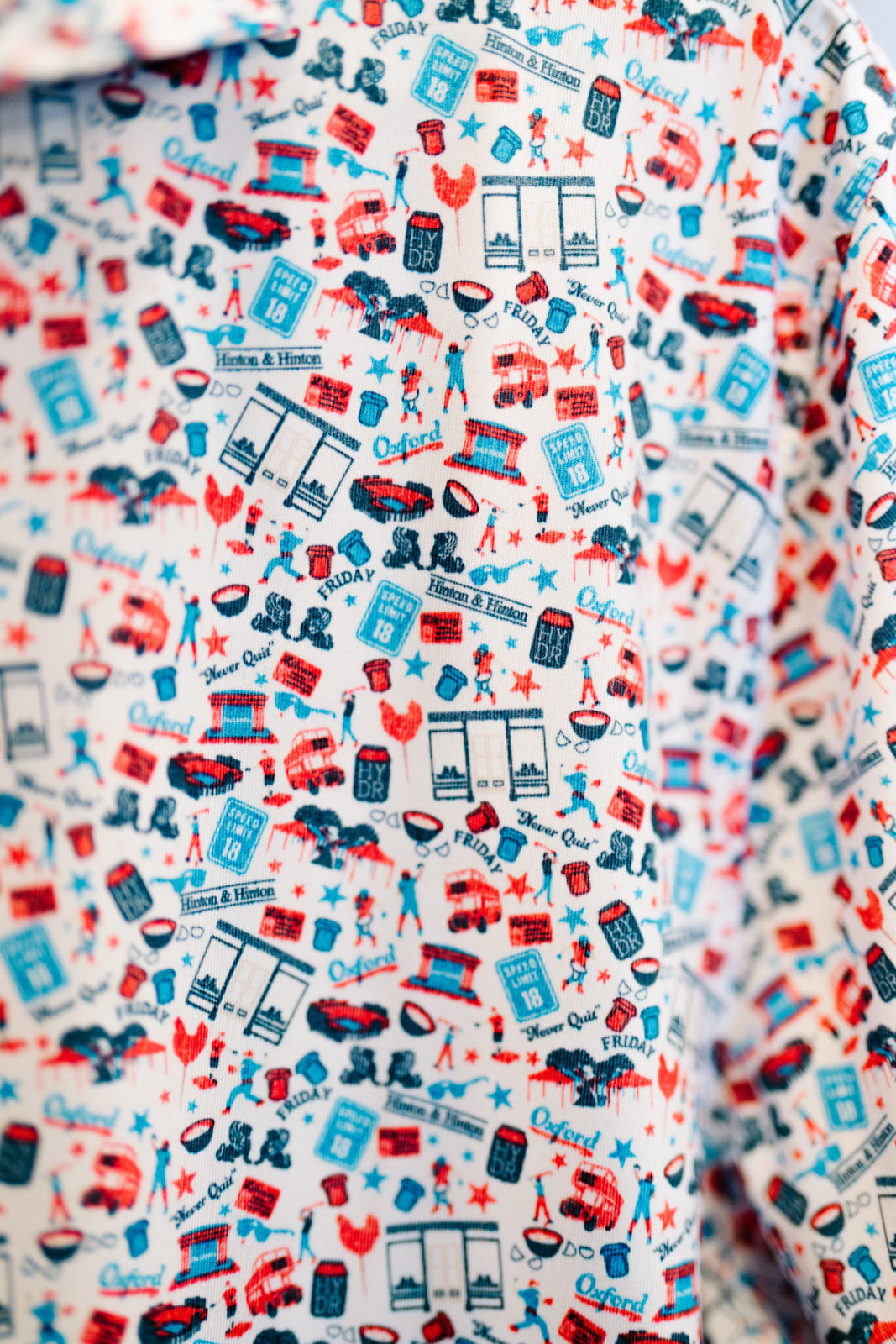 Close-up of a patterned fabric with red, blue, and white designs.